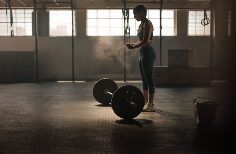 Strong woman preparing for weightlifting workout
